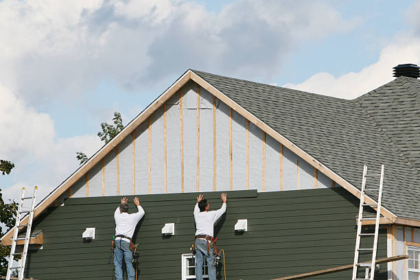 Professional Siding technician working in Northport, NY